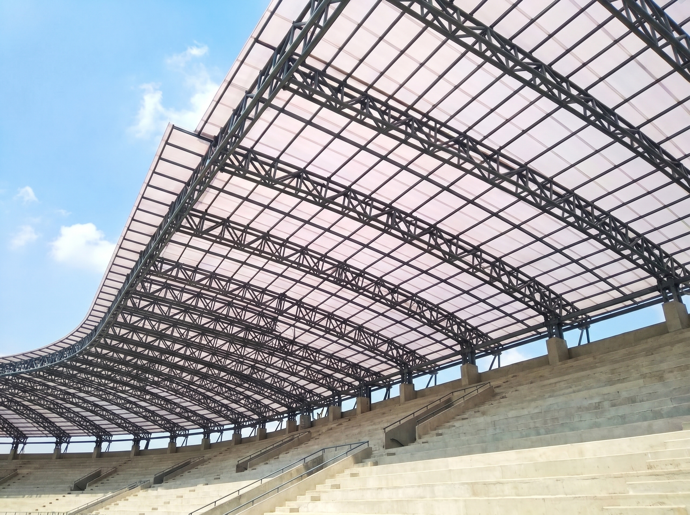 Stadium canopy — daylight at the scale of sport. — Coxwell